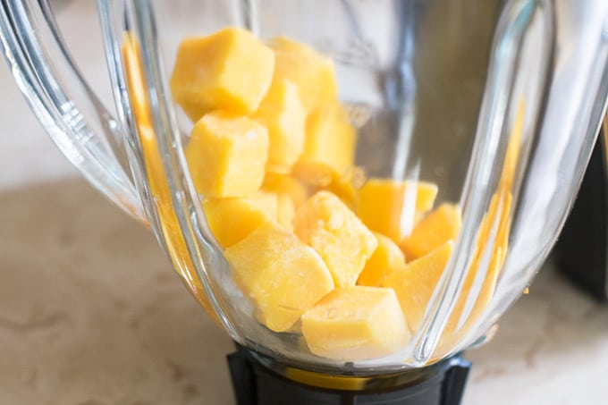 frozen mango cubes in a blender