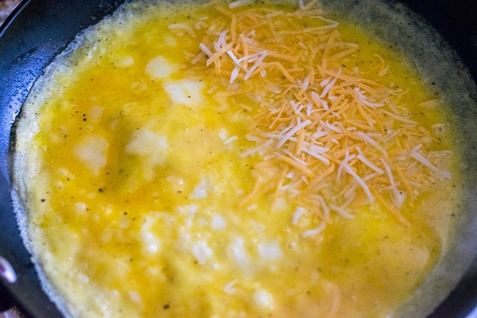 Cheese omelet cooking in a skillet.