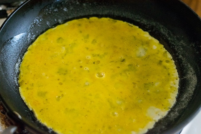 Eggs cooking in a skillet.