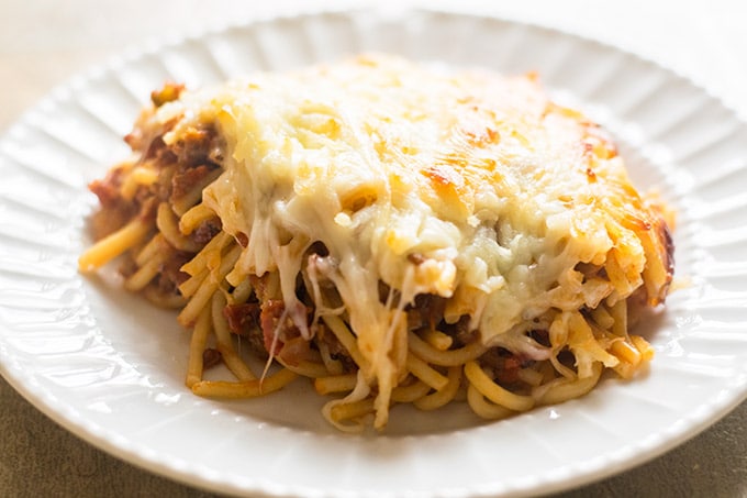 baked spaghetti on a white plate.