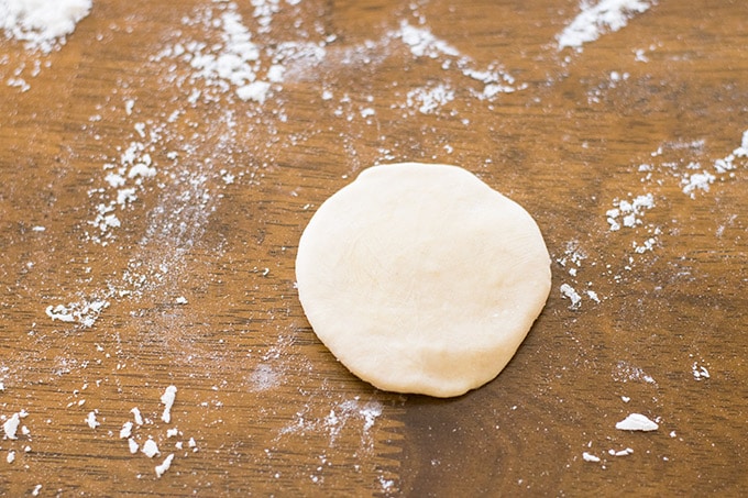 flattened dough ball before rolling