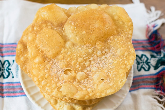 stack of mexican bunuelos on a white plate
