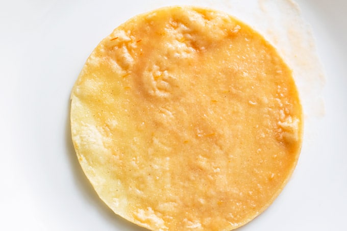 tortilla dipped in tomato sauce