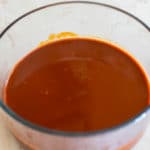 red enchilada sauce in a clear bowl