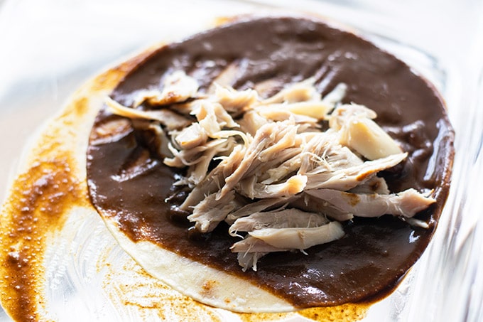 tortilla dipped in mole sauce and filled with shredded chicken