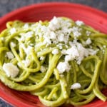 green spaghetti on a red plate