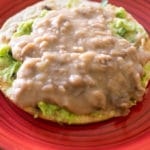refried bean tostada on a red plate