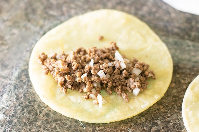 ground beef filling in a corn tortilla