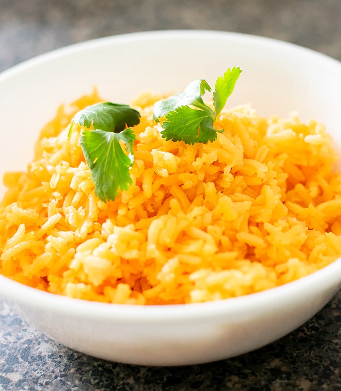 super easy mexican rice in a white bowl garnished with cilantro