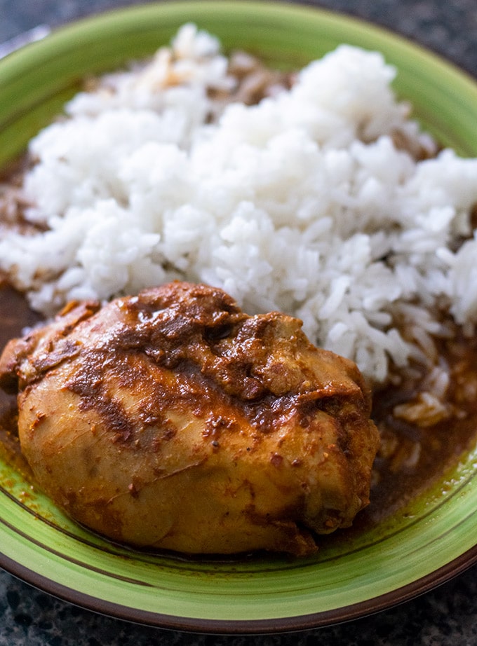 mixiote de pollo on a green plate with rice