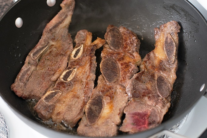 browned beef short ribs in skillet