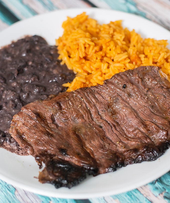 carne asada on a plate with rice and beans