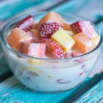 Mexican fruit salad with cream in a bowl