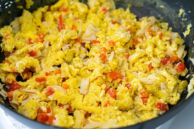 scrambled eggs and turkey in a skillet