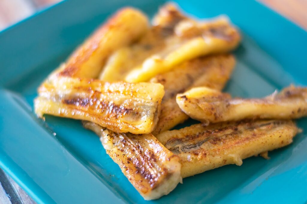 Mexican fried bananas on a blue plate.