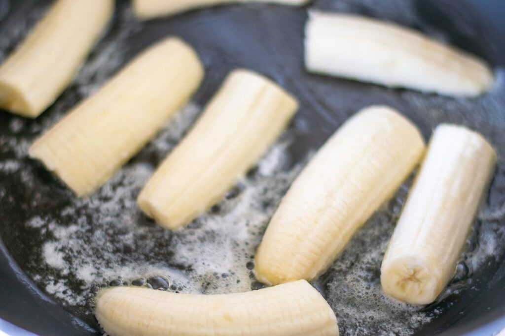 frying bananas in a skillet.