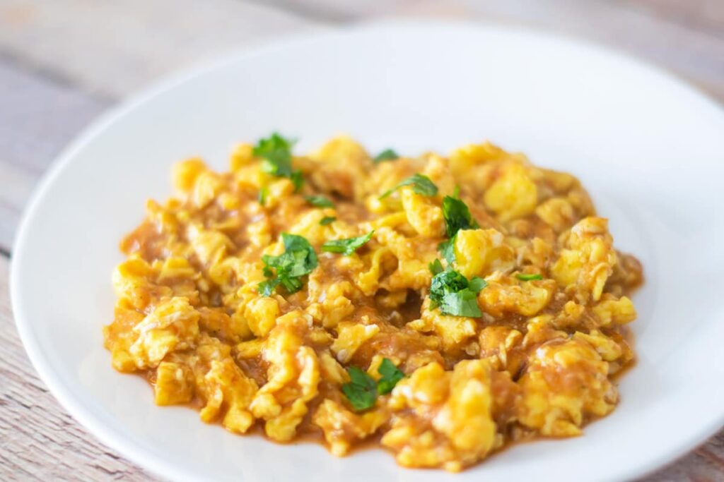 huevos en salsa on a white plate