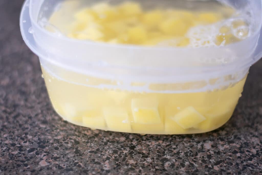 diced potatoes in a bowl covered with water.