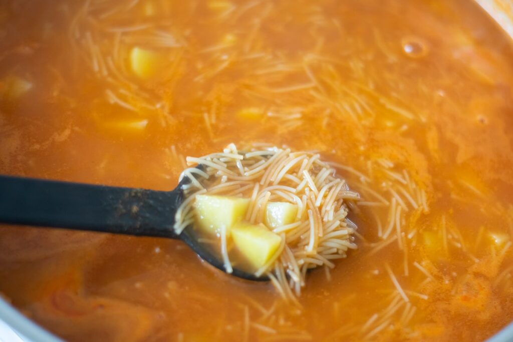 sopa con papas in a skillet.