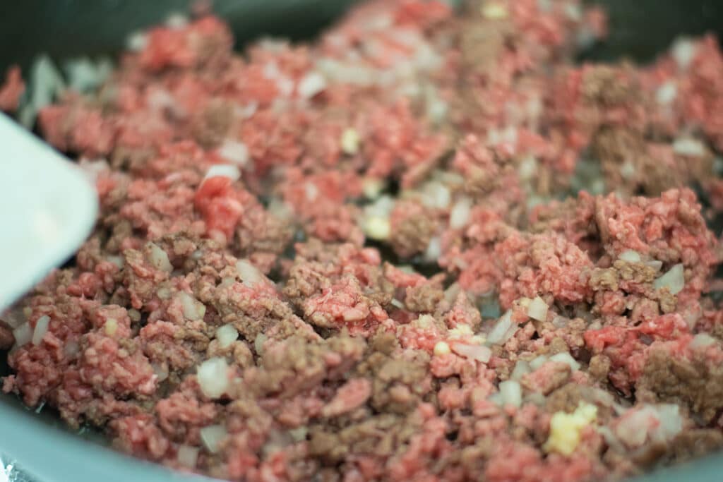 browning ground beef in a skillet.