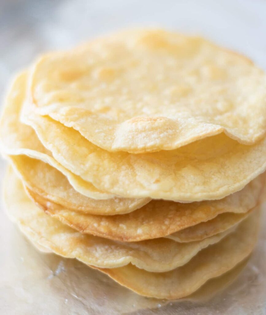 A stack of baked tostada shells.