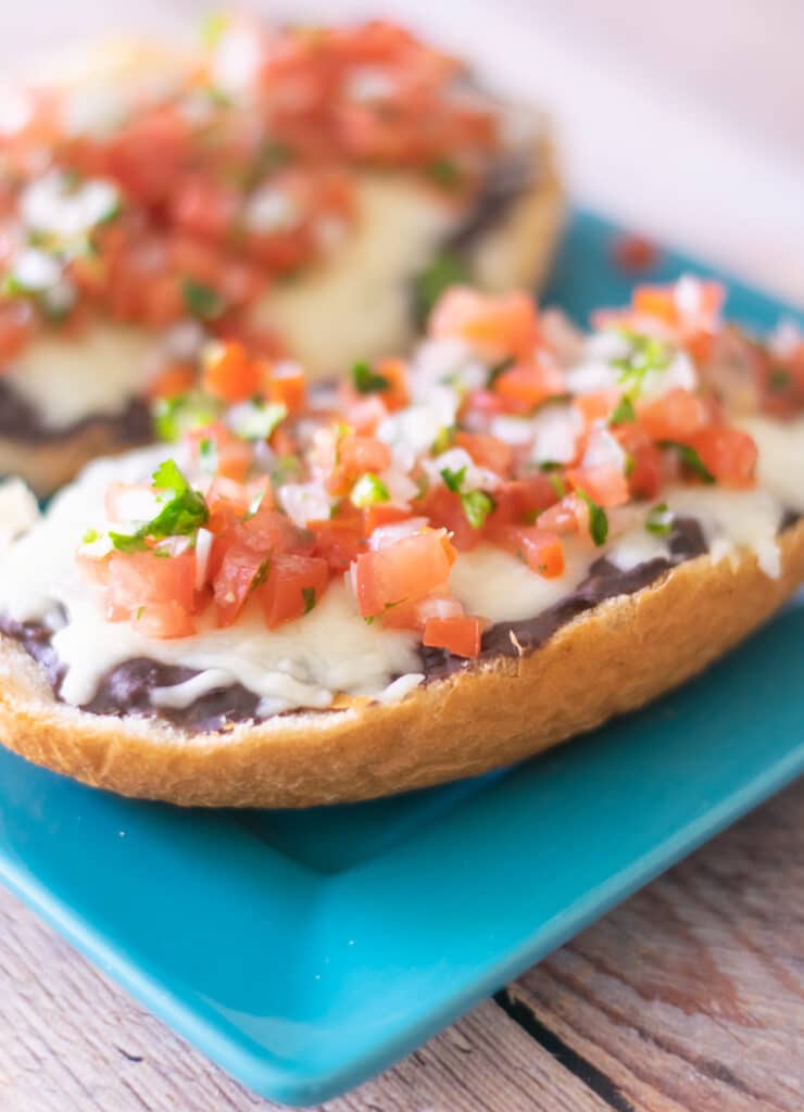 molletes on a blue plate.
