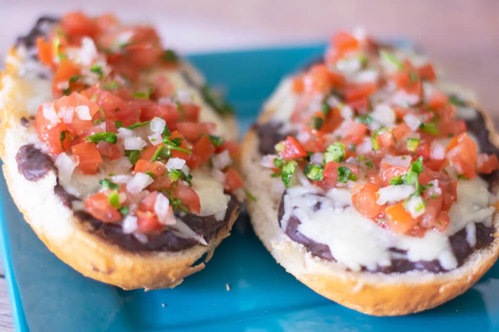 two molletes on a blue plate.