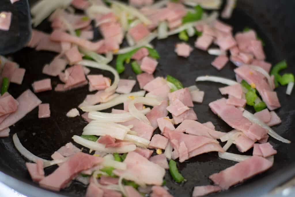 ham, jalapeno and onion in a skillet.