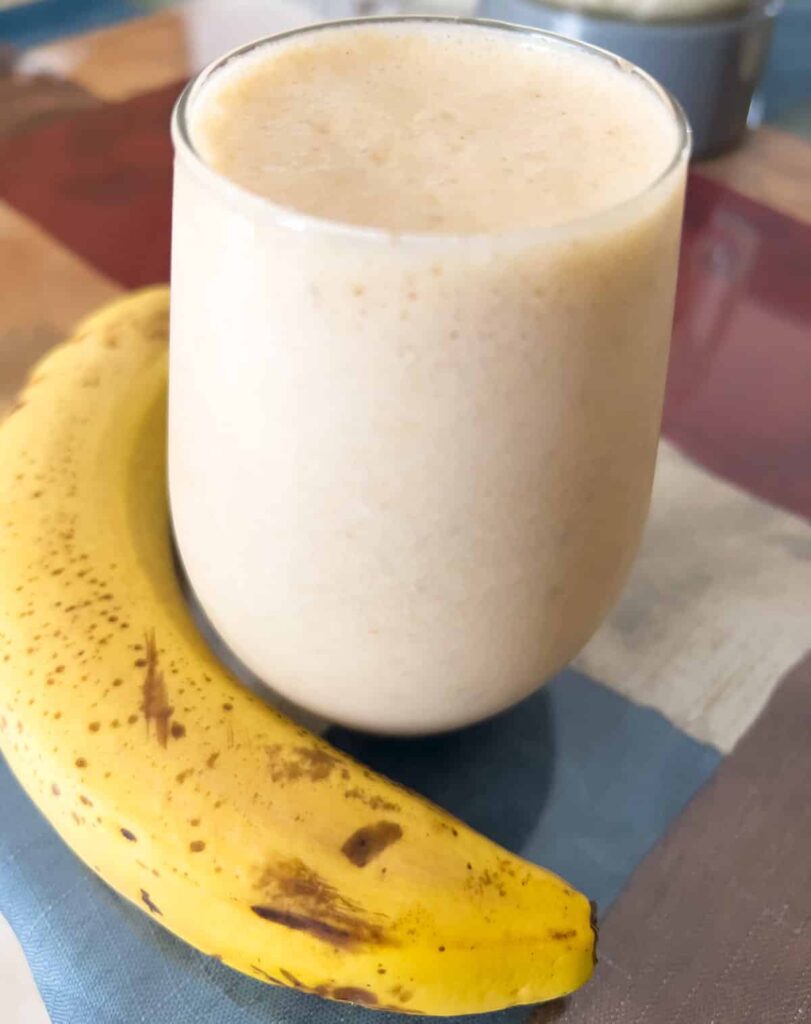 An oat milk breakfast smoothie in a glass.
