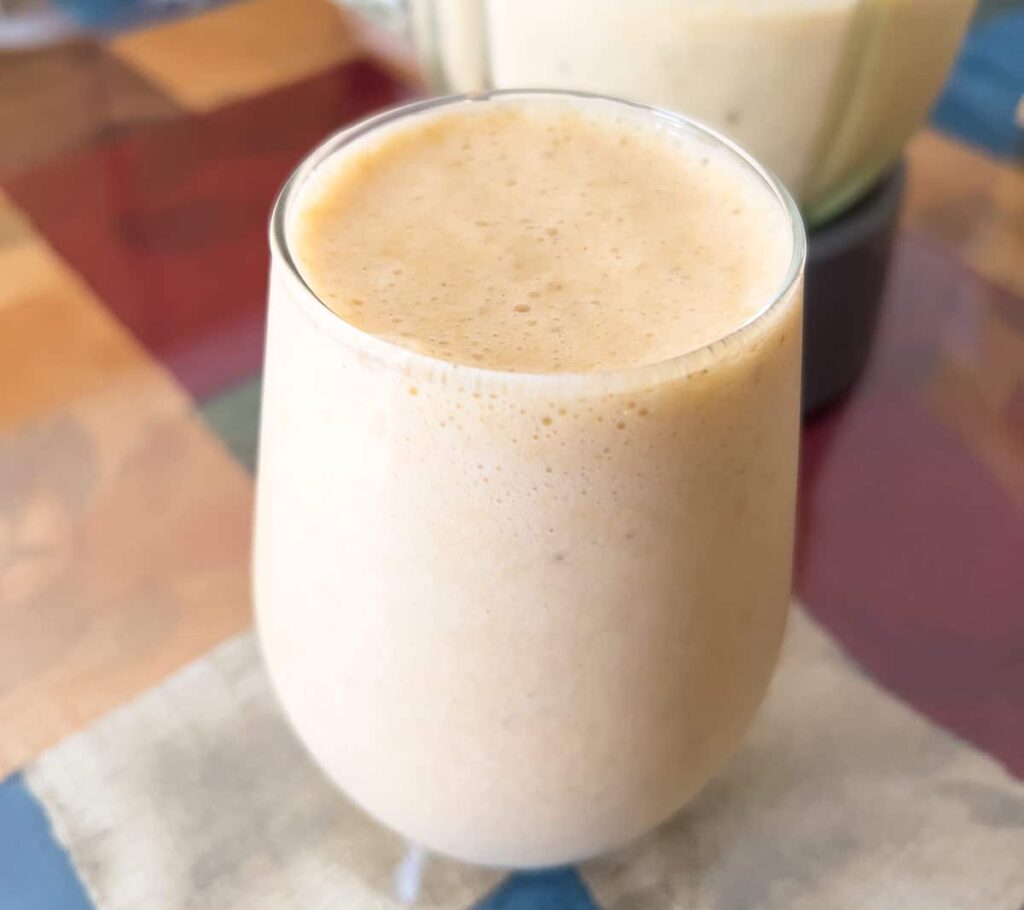 Banana smoothie with oat milk in a glass.