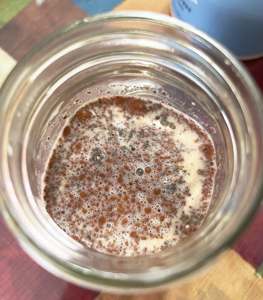 A mason jar with chia pudding ingredients.