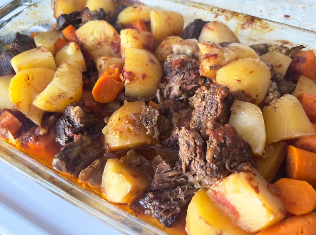 Onion soup mix beef stew in a casserole dish.