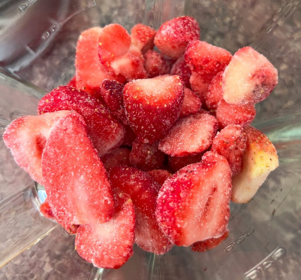 Frozen strawberries in a blender.