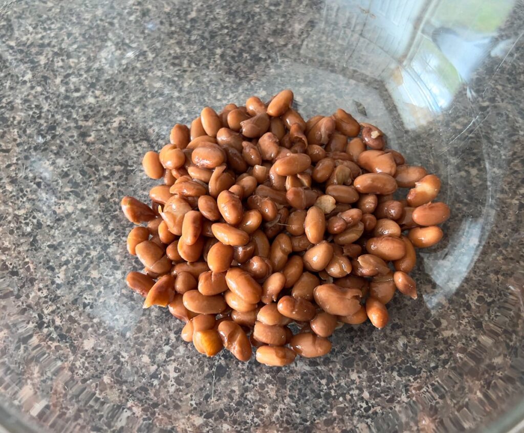 Pinto beans in a glass bowl.