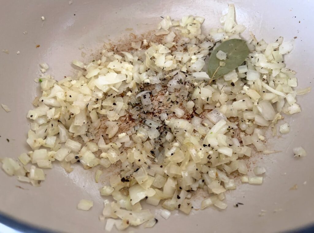 Diced onion and aromatics in a dutch oven.