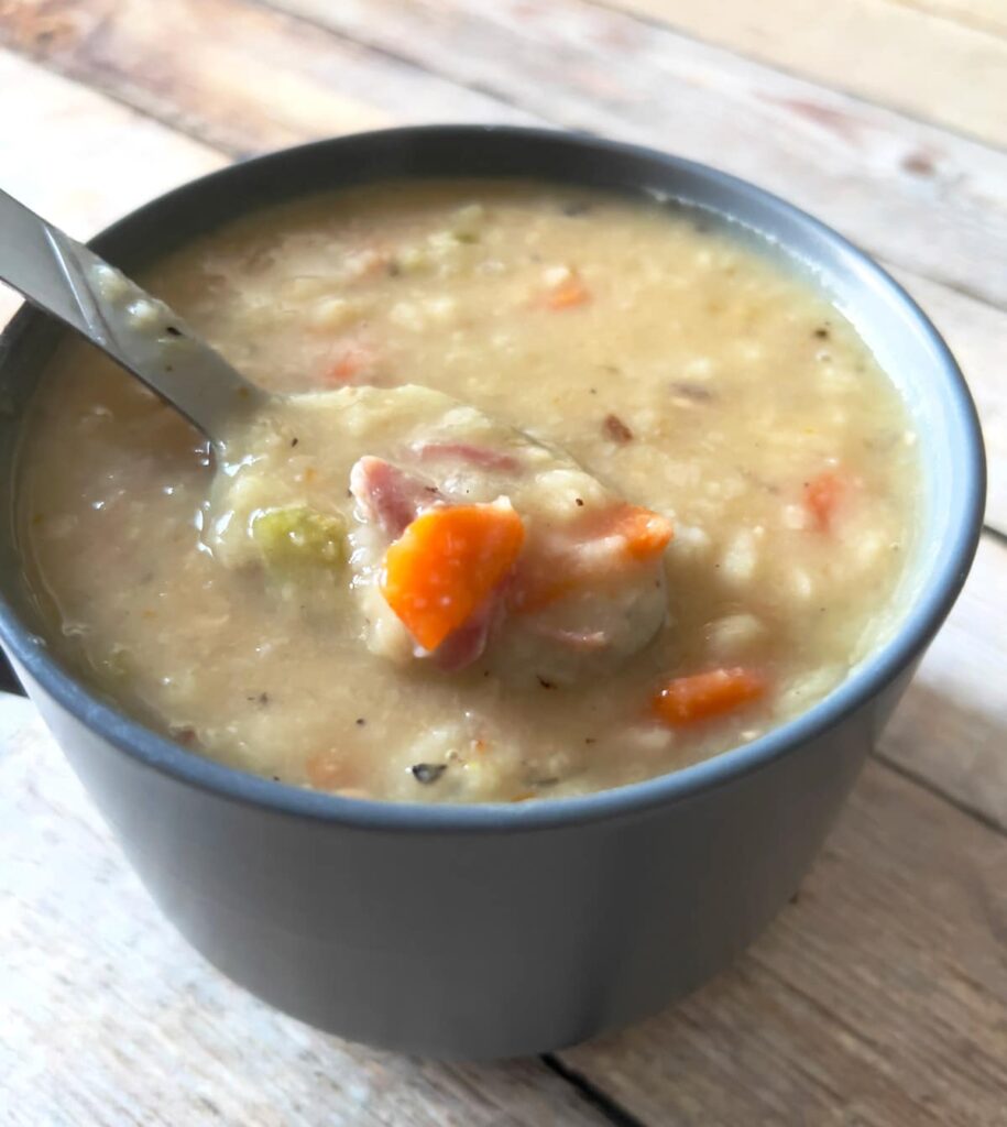 White bean and ham hock soup in a mug.
