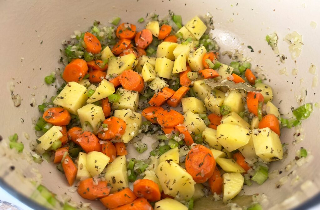 Diced vegetables in a dutch oven.