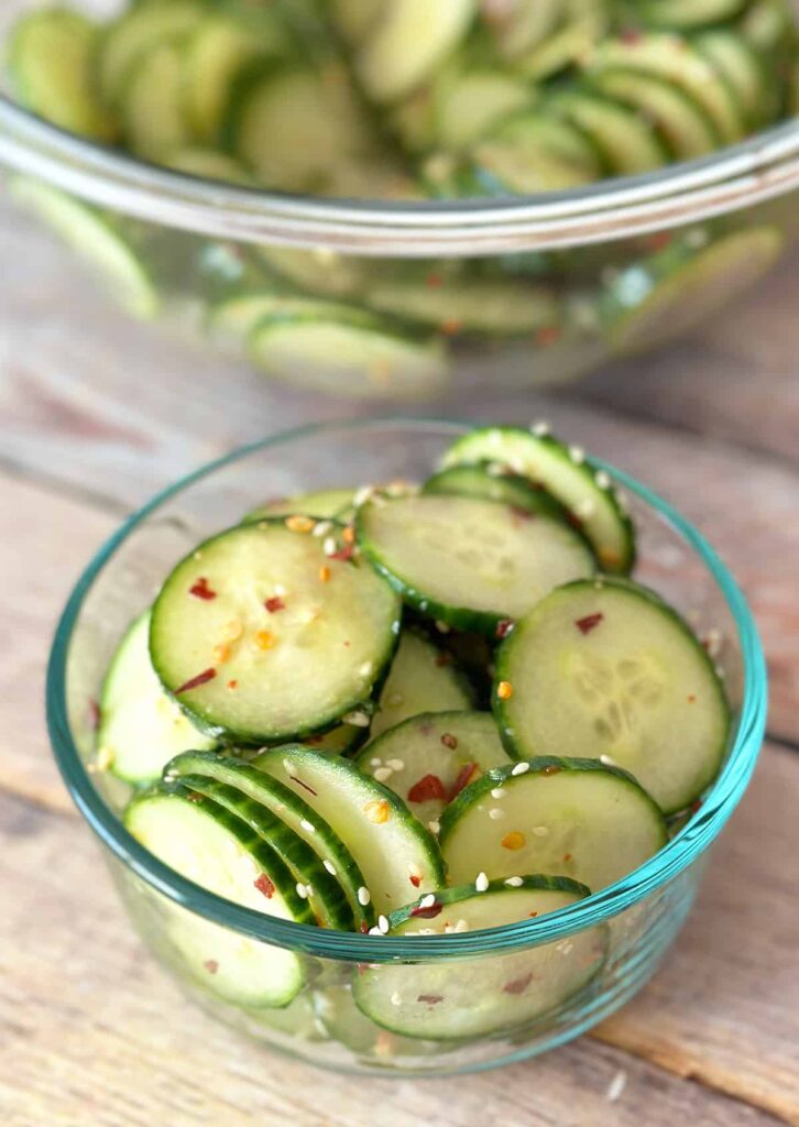 Spicy asian cucumber salad in a small glass bowl.