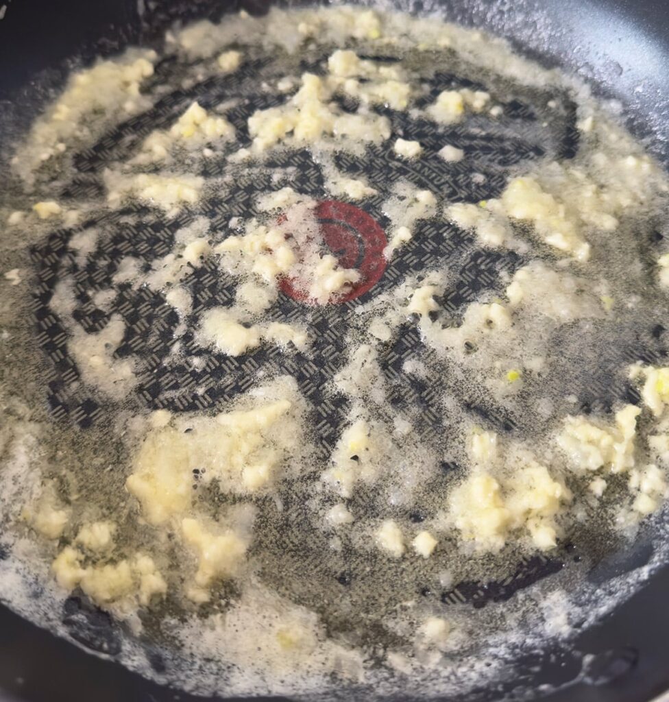 Sautéing onion and garlic in butter.