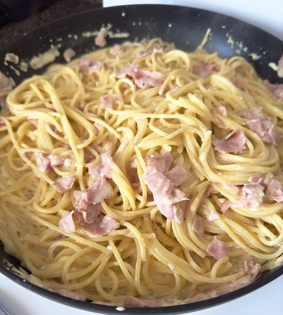 Mexican white spaghetti with ham in a skillet.