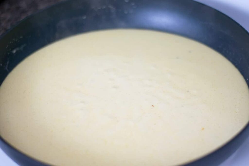 Dijon mustard cream sauce in a skillet.