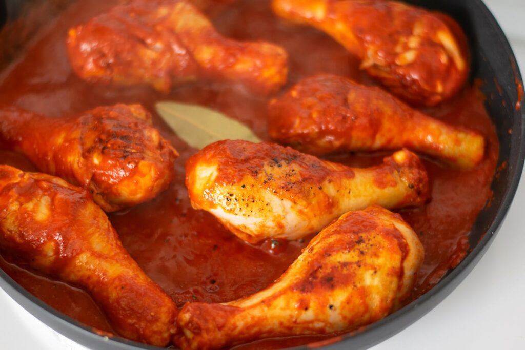 chicken in red sauce in a skillet.