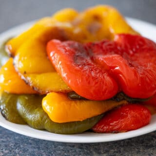 Roasted bell peppers on a white plate.
