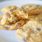 Chocolate chip cookies on a white plate.