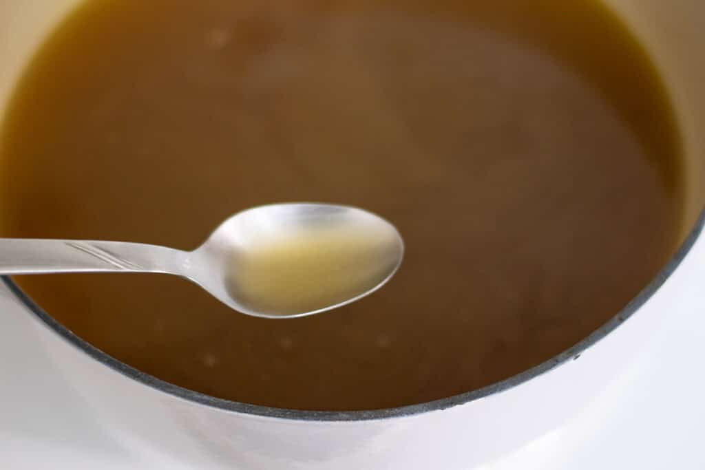 Homemade chicken bone broth in a pot.