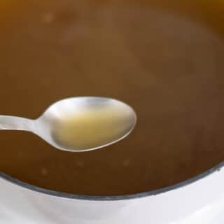 Homemade chicken bone broth in a pot.