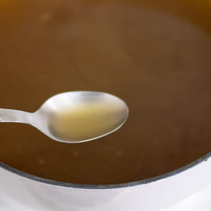 Homemade chicken bone broth in a pot.