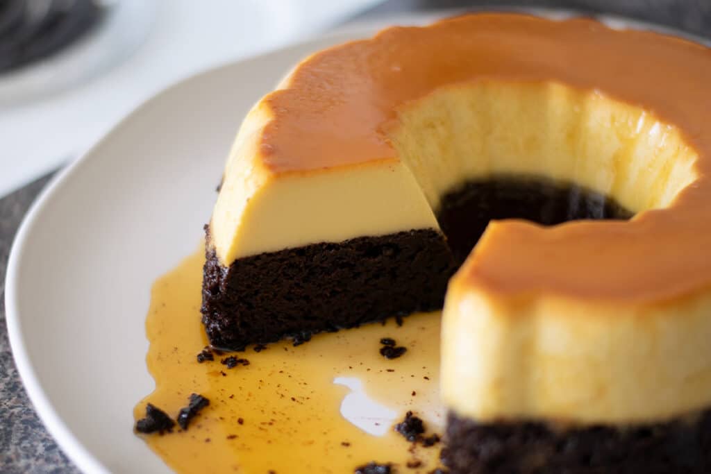 Chocoflan on a plate with a slice cut out.