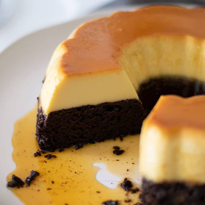 Chocoflan on a plate with a slice cut out.