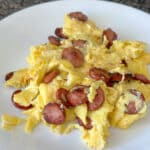 Huevos con salchicha on a white plate.